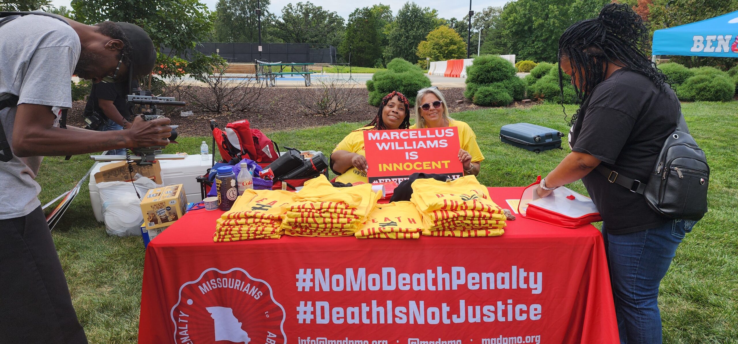 A Group of People Gathered Around a Table With a Cloth